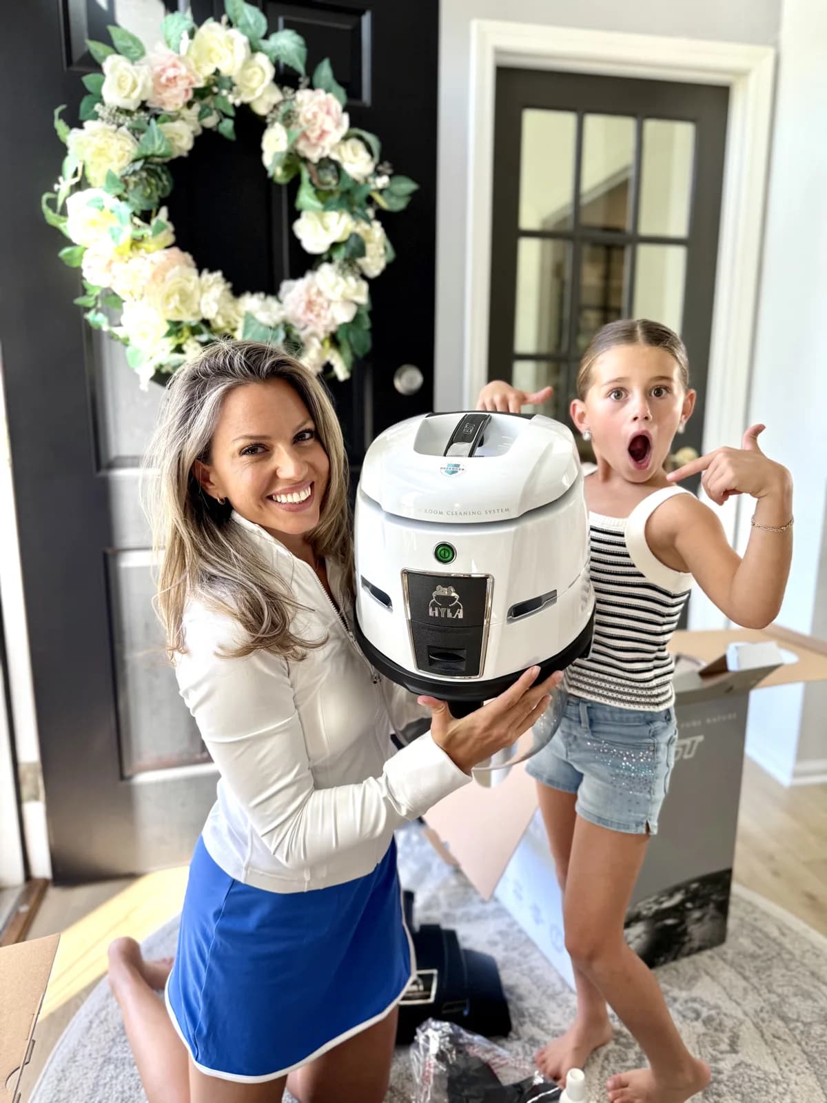 Woman and excited girl unboxing a HYLA cleaning system